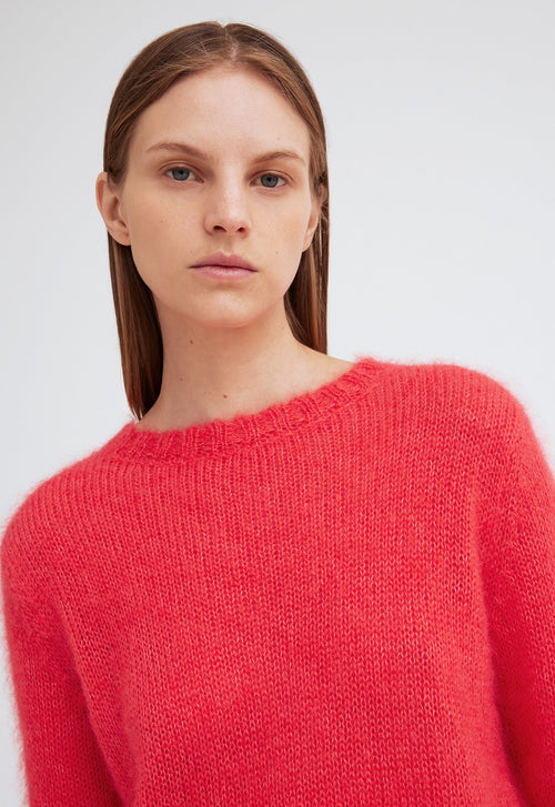 A woman wearing a blouse and skirt